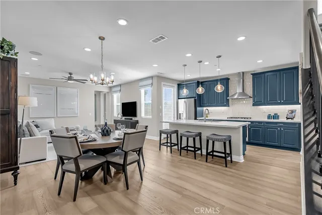 a large kitchen with a table and chairs