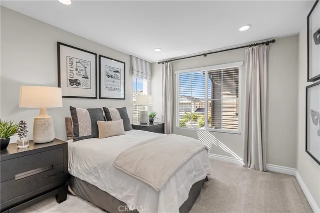 a spacious bedroom with a bed and a window