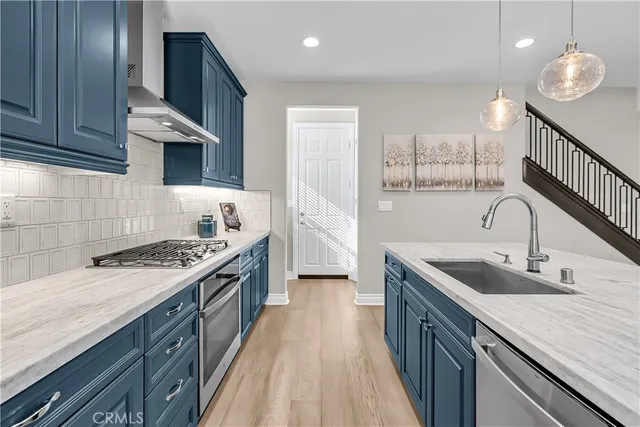 a kitchen with stainless steel appliances granite countertop a sink stove and cabinets