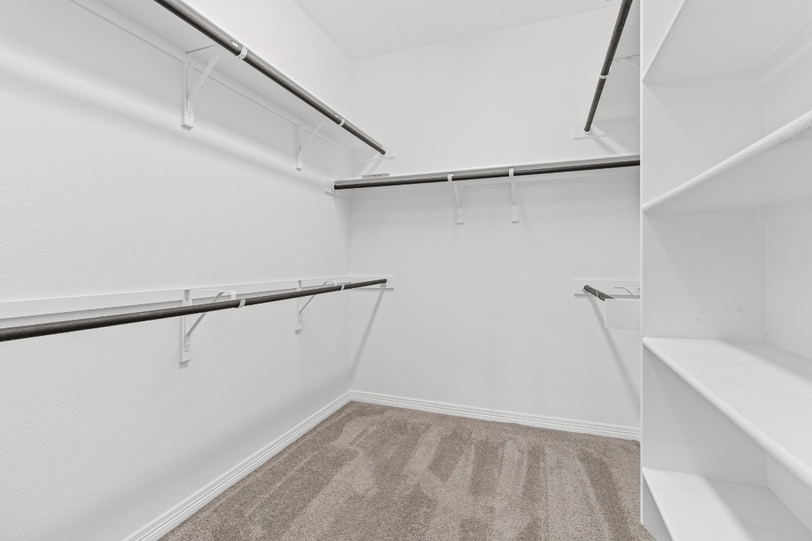 20520 Carries Ranch Road Pflugerville, TX 78660 - Photo 13 of 32 a view of walk in closet with empty racks