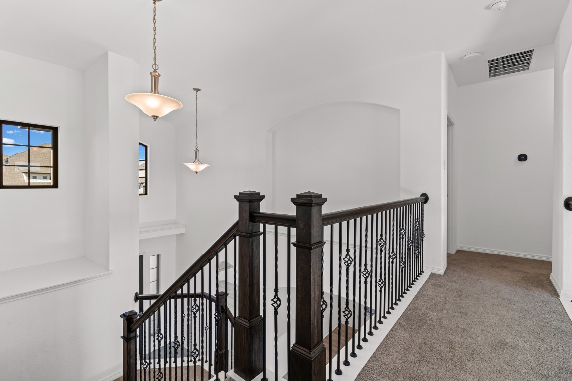 20520 Carries Ranch Road Pflugerville, TX 78660 - Photo 16 of 32 a view of a hallway with a chandelier