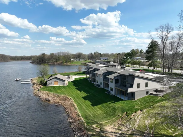 a view of a house with roof deck and garden