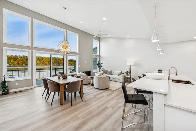 a view of a dining room with furniture large windows and wooden floor