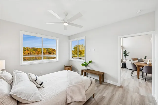 a bedroom with a bed and wooden floor