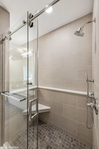 a bathroom with a shower and a glass door