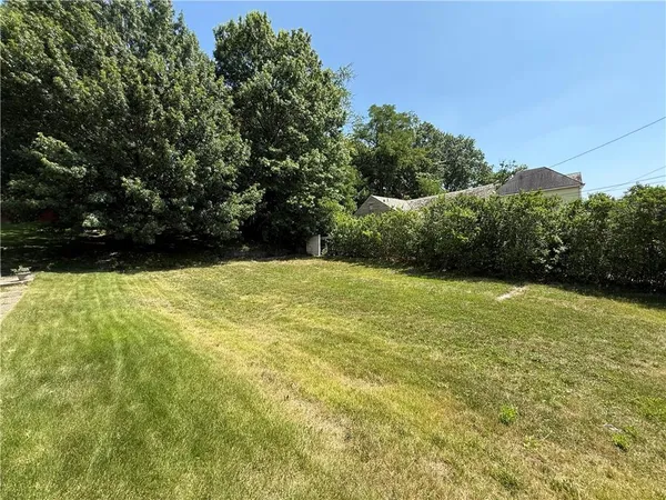 a view of yard with swimming pool and green space