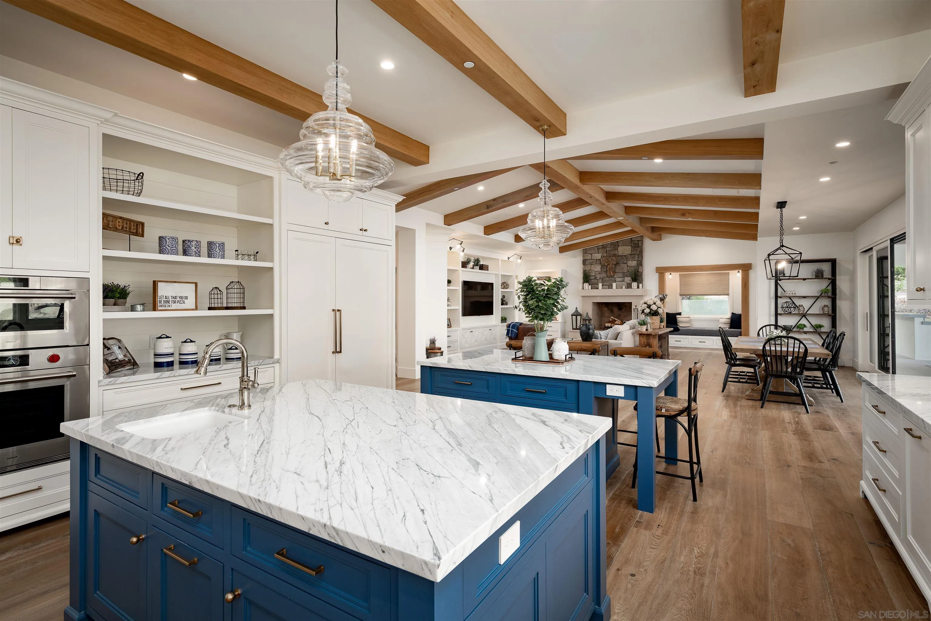 3419 Via Monteverde Encinitas, CA 92024 - Photo 18 of 73 a kitchen with granite countertop a table chairs and wooden floor