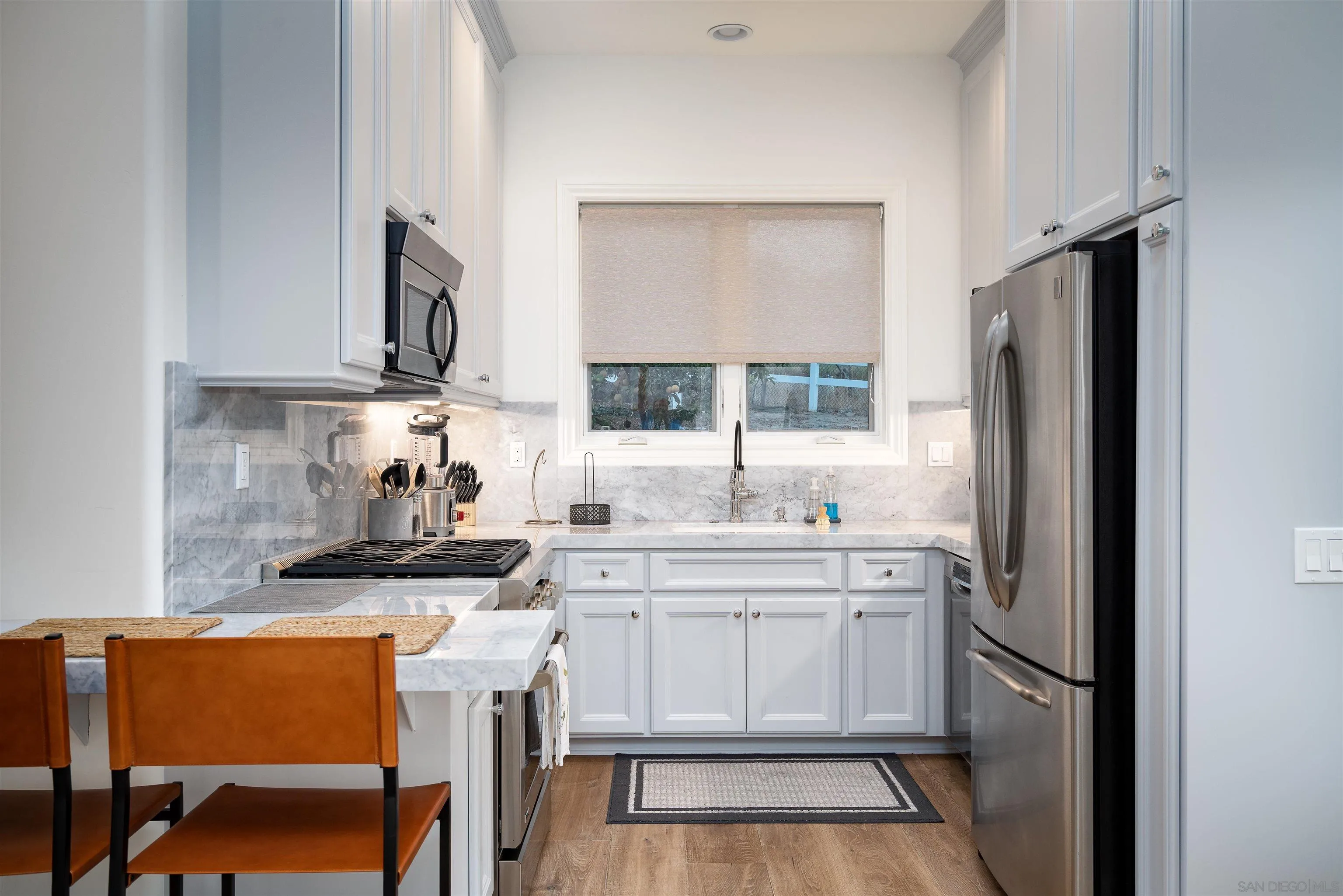 3419 Via Monteverde Encinitas, CA 92024 - Photo 41 of 73 a kitchen with stainless steel appliances a stove refrigerator sink and cabinets