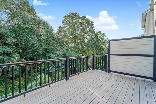 a balcony with wooden floor and fence