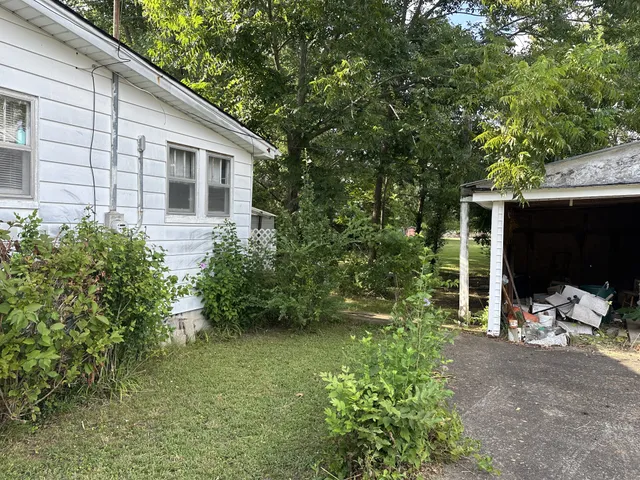 a backyard of a house with outdoor seating and plants
