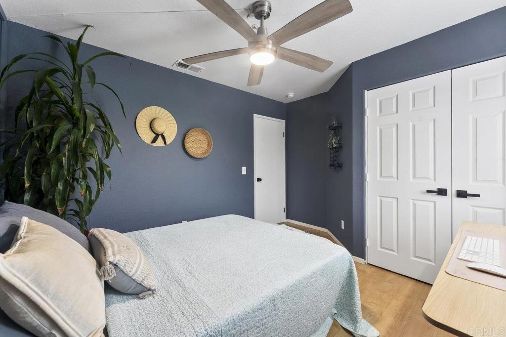 305 Cobblestone Place Santee, CA 92071 - Photo 26 of 41 a bedroom with a bed and a chandelier