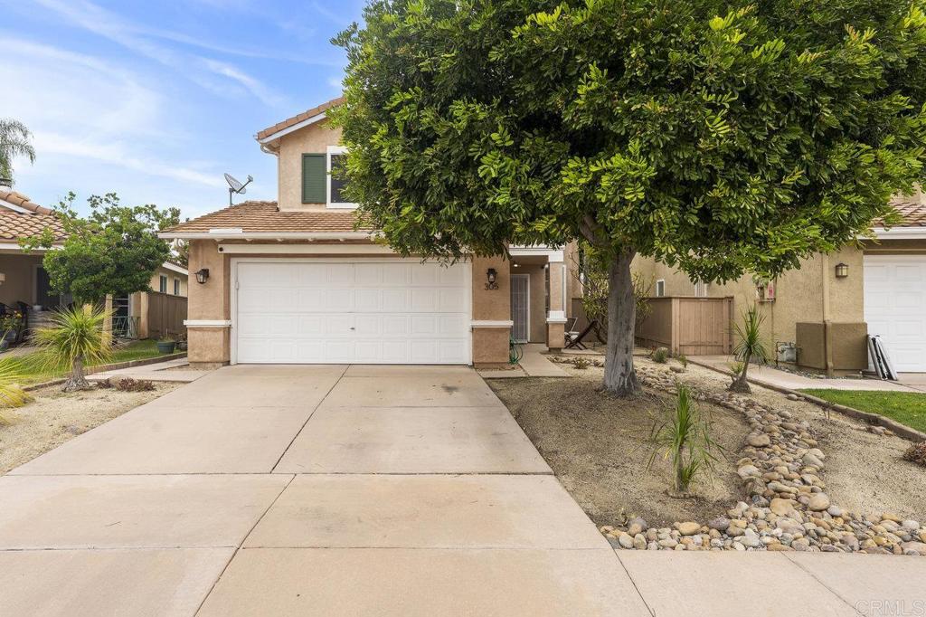 305 Cobblestone Place Santee, CA 92071 - Photo 3 of 41 a front view of a house with a yard and garage