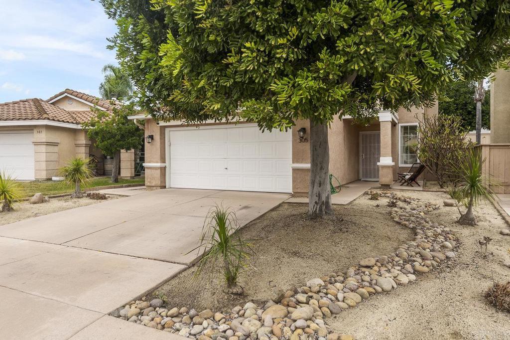 305 Cobblestone Place Santee, CA 92071 - Photo 38 of 41 a front view of a house with a yard and garage