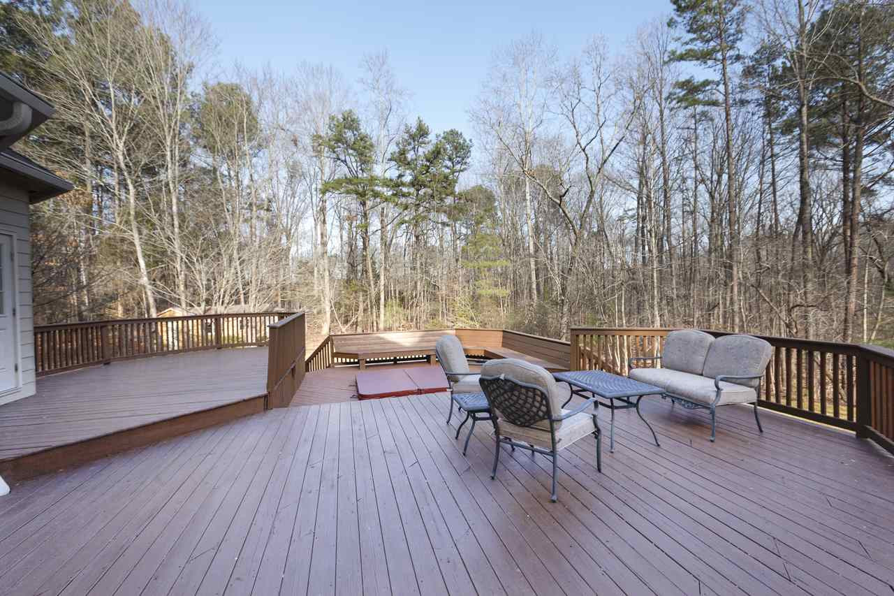 12312 Galway Drive Raleigh, NC 27613 - Photo 23 of 25 Entertain family and friends on the three-tiered back deck that includes an in-ground hot tub and peaceful wooded views. Deck