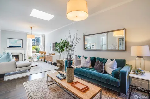 a living room with furniture and a chandelier