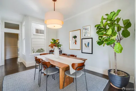 a view of a dining room with furniture and chandelier