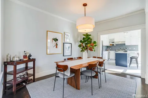 a kitchen with stainless steel appliances kitchen island a refrigerator sink and cabinets