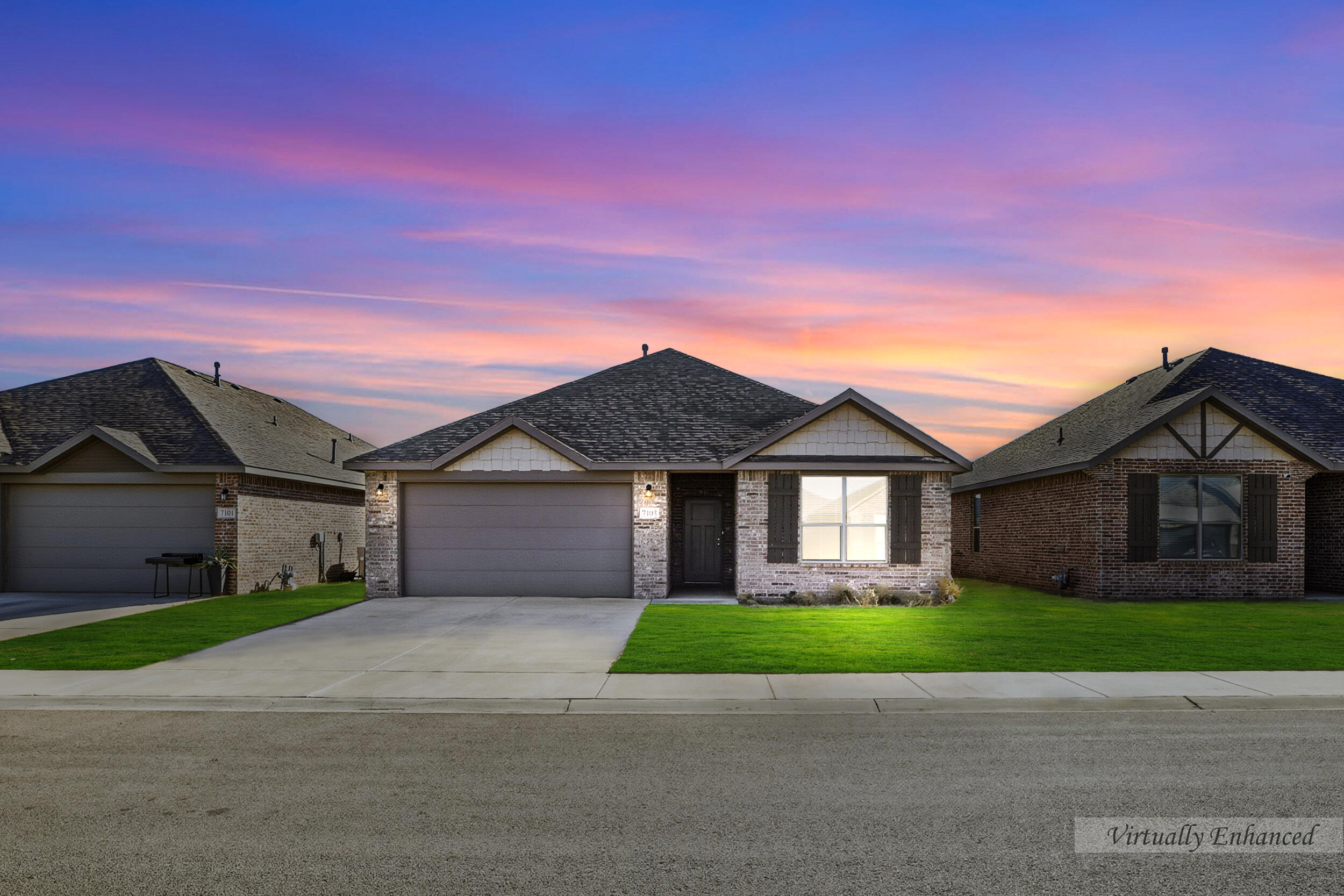 a view of a brick house next to a yard with large trees