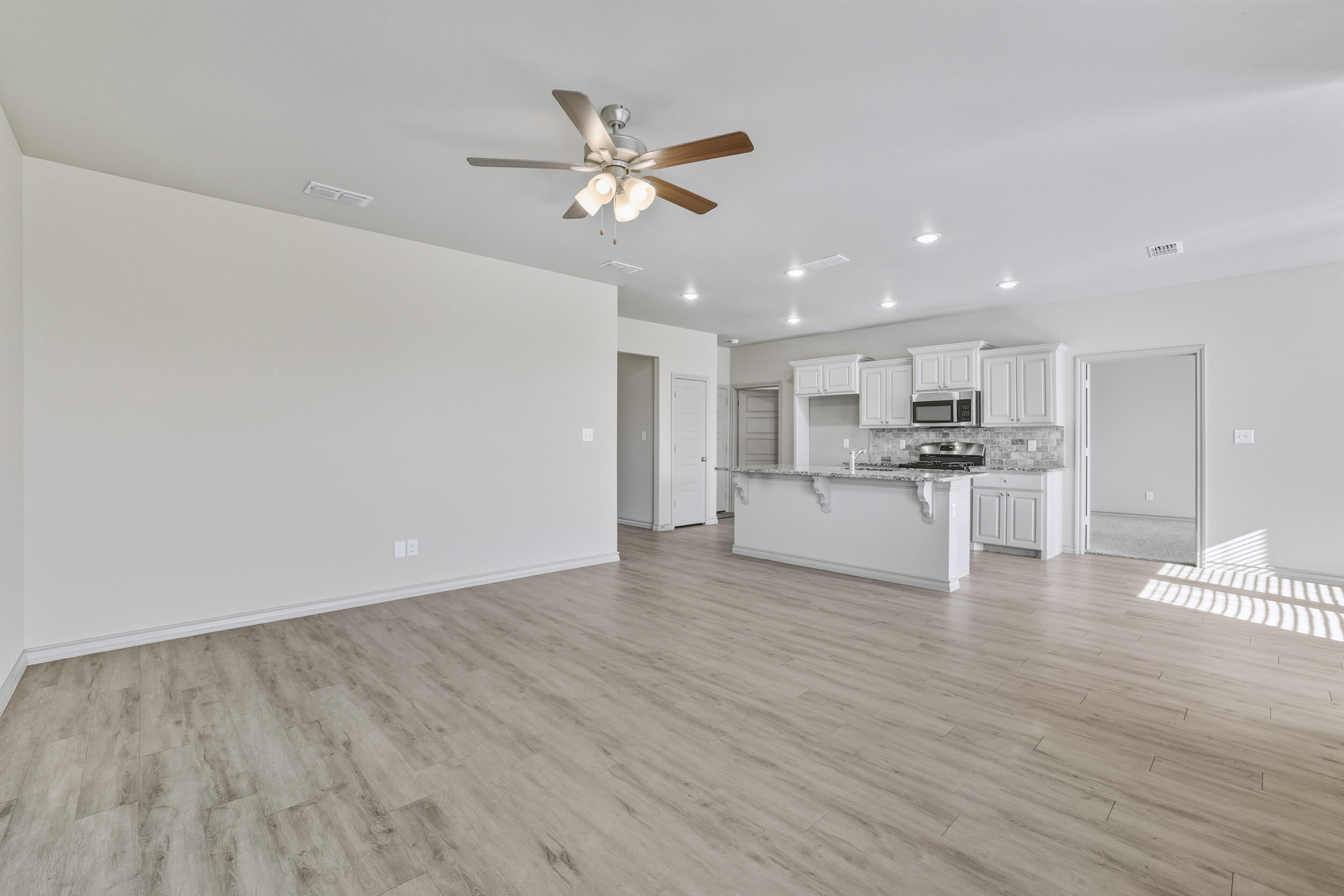 7103 22nd Street Lubbock, TX 79407 - Photo 11 of 30 a view of kitchen with granite countertop cabinets and refrigerator