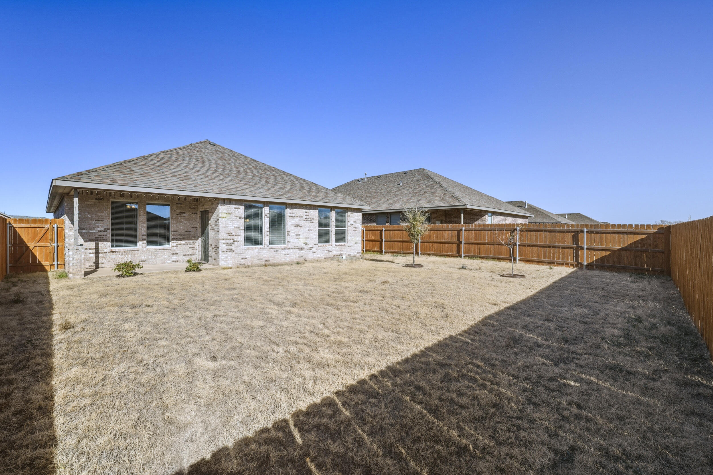 7103 22nd Street Lubbock, TX 79407 - Photo 28 of 30 a front view of a house with a yard