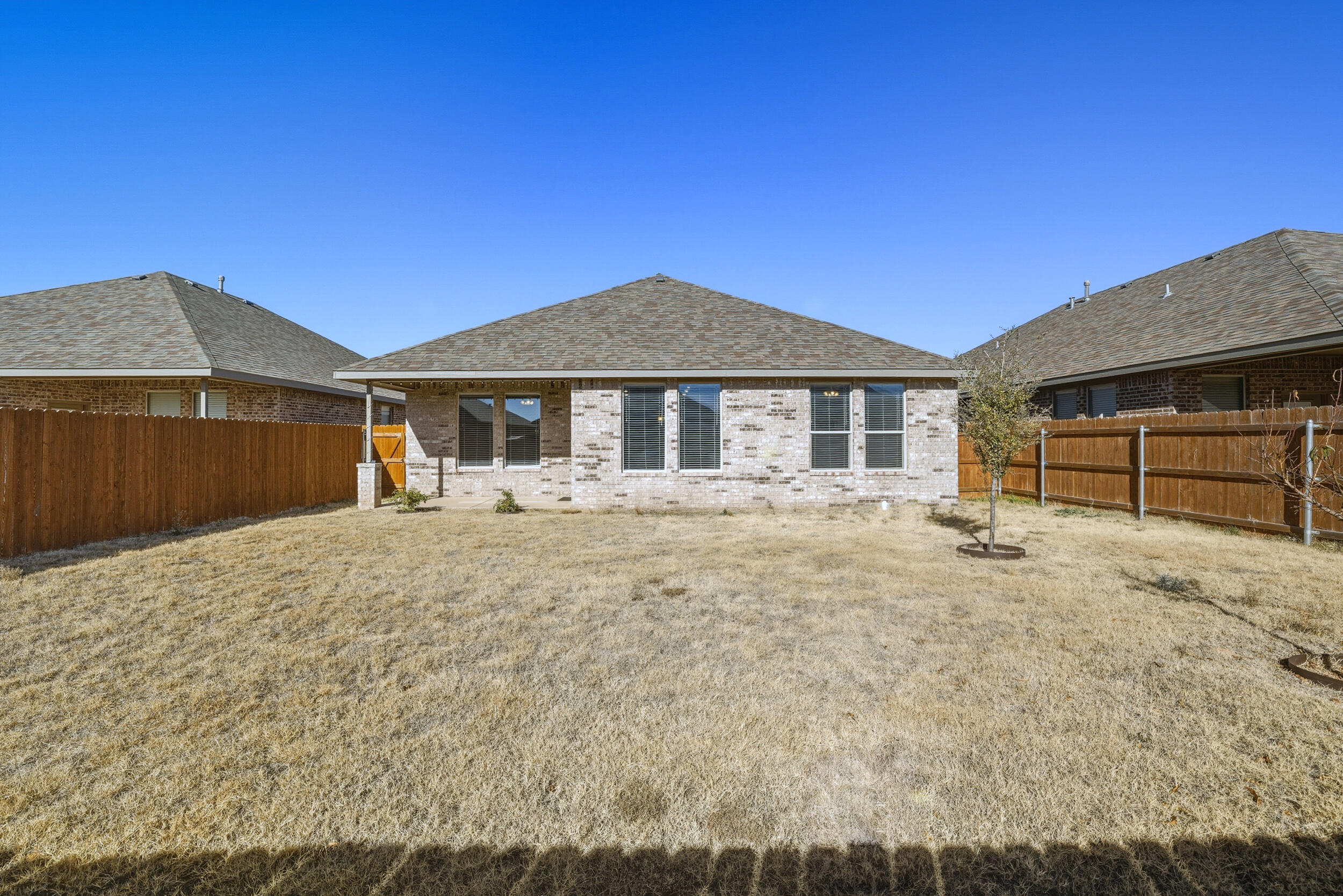 7103 22nd Street Lubbock, TX 79407 - Photo 29 of 30 a front view of a house with a yard