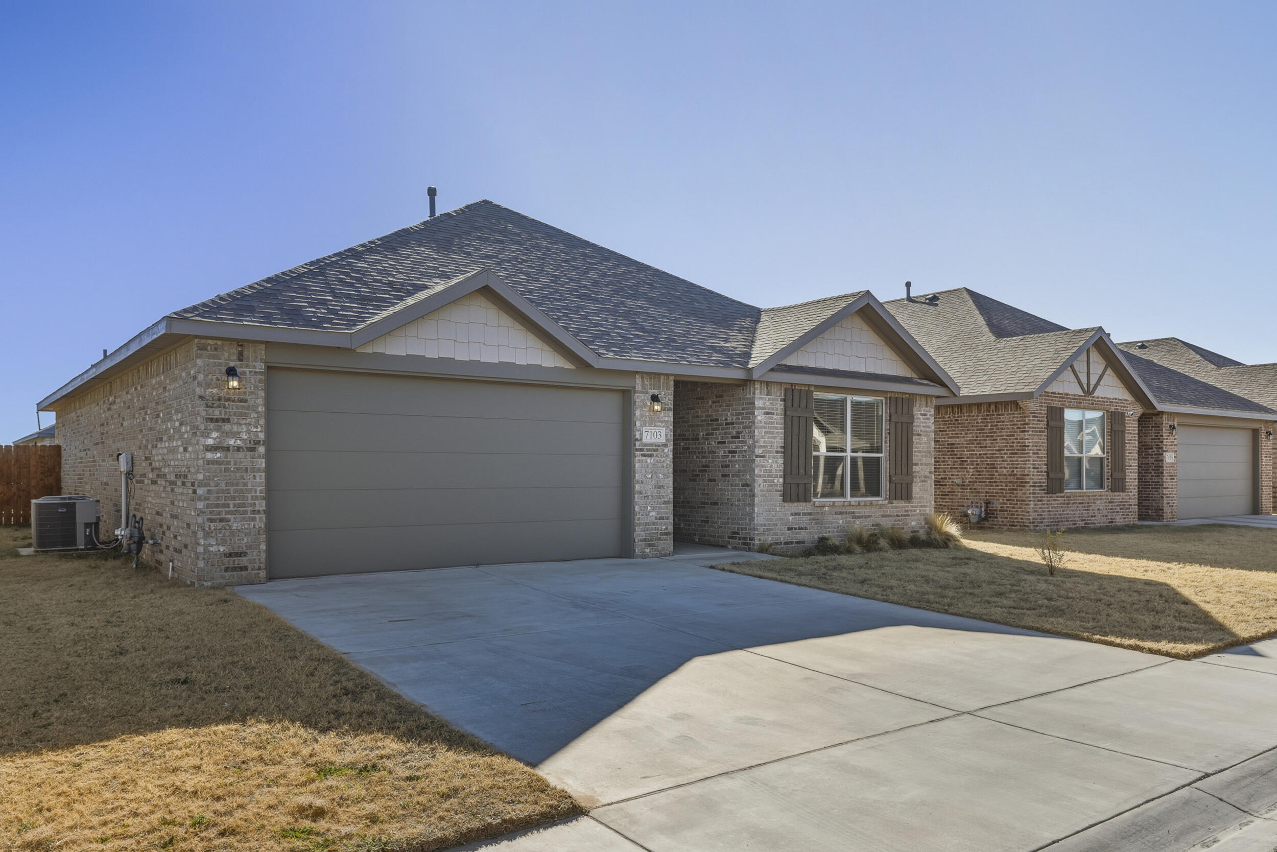 7103 22nd Street Lubbock, TX 79407 - Photo 3 of 30 a front view of a house with a yard and garage