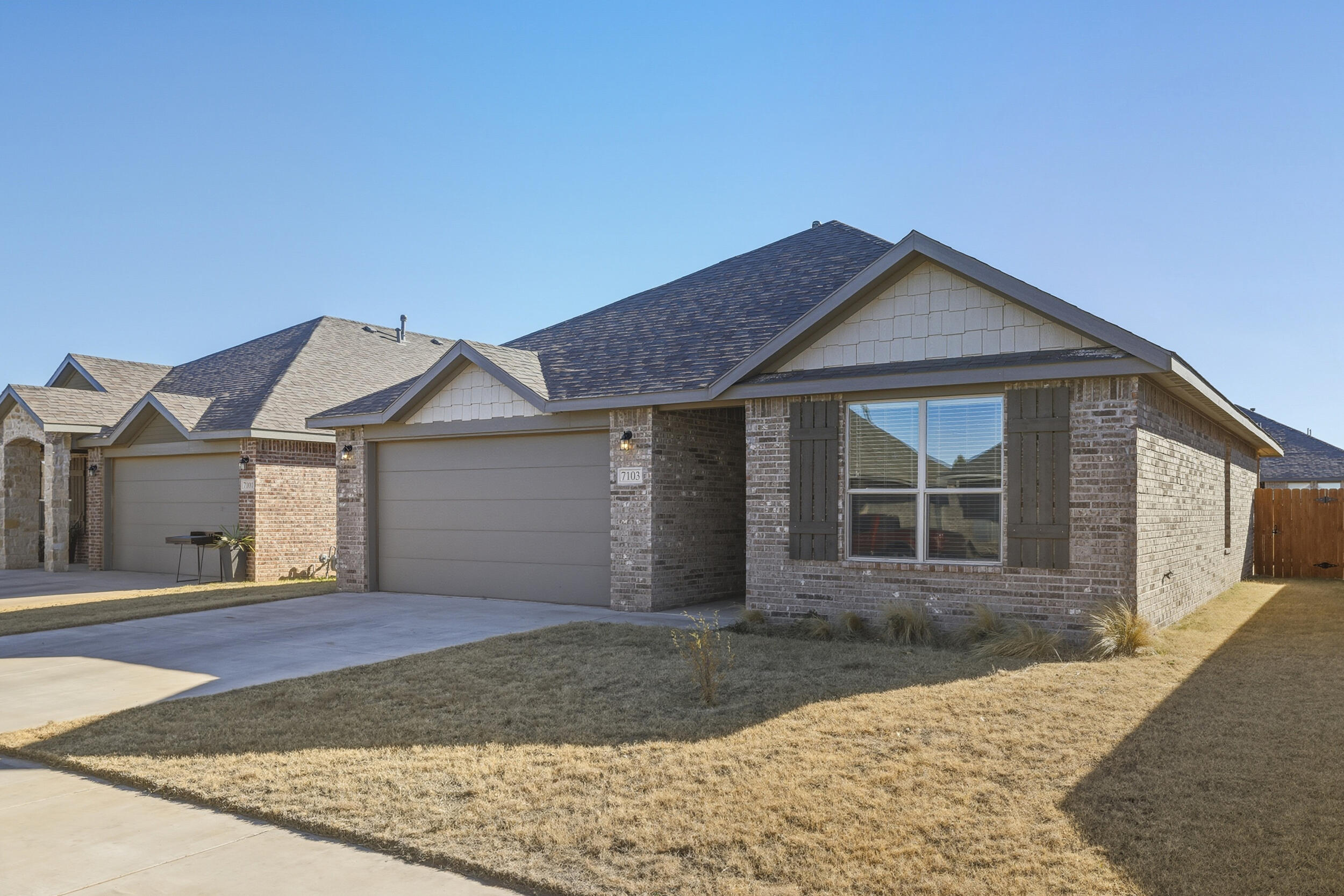 7103 22nd Street Lubbock, TX 79407 - Photo 4 of 30 a front view of a house with a yard and garage