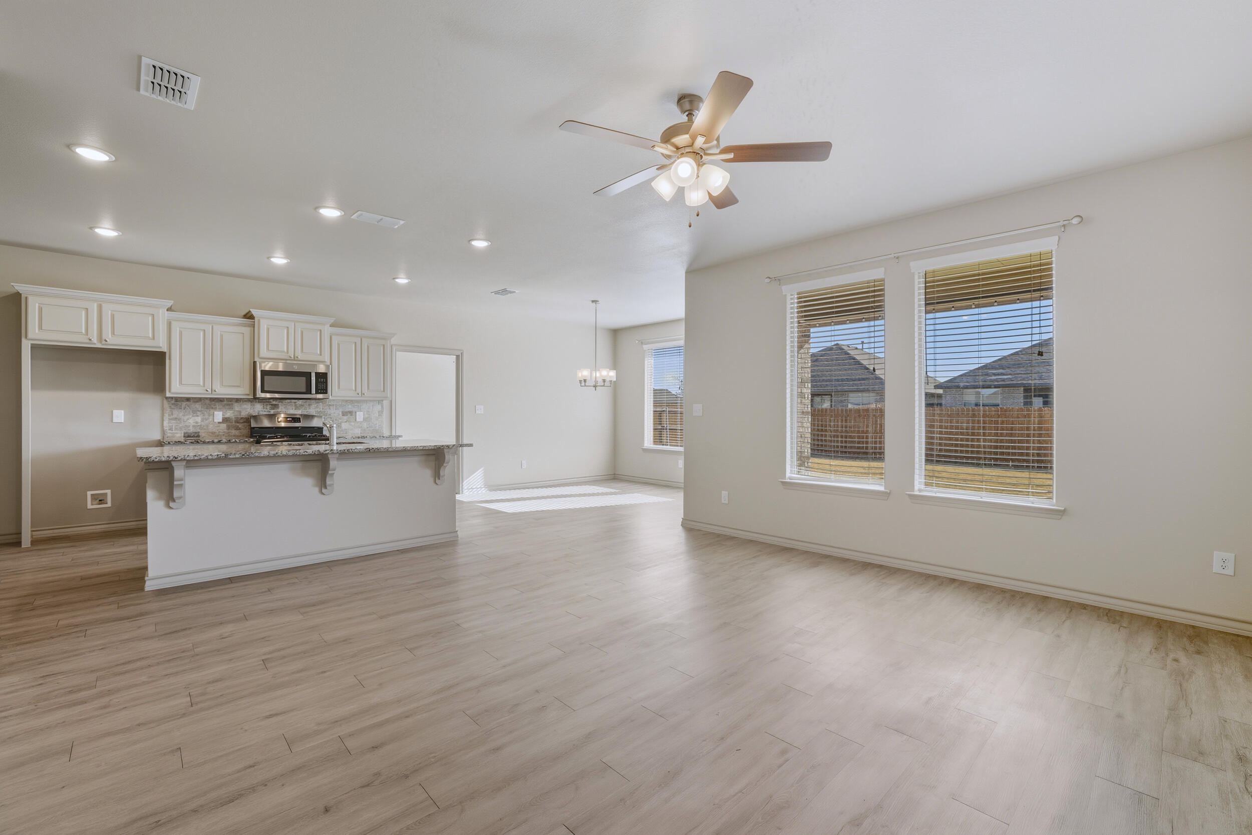 7103 22nd Street Lubbock, TX 79407 - Photo 6 of 30 a view of an empty room with kitchen and window
