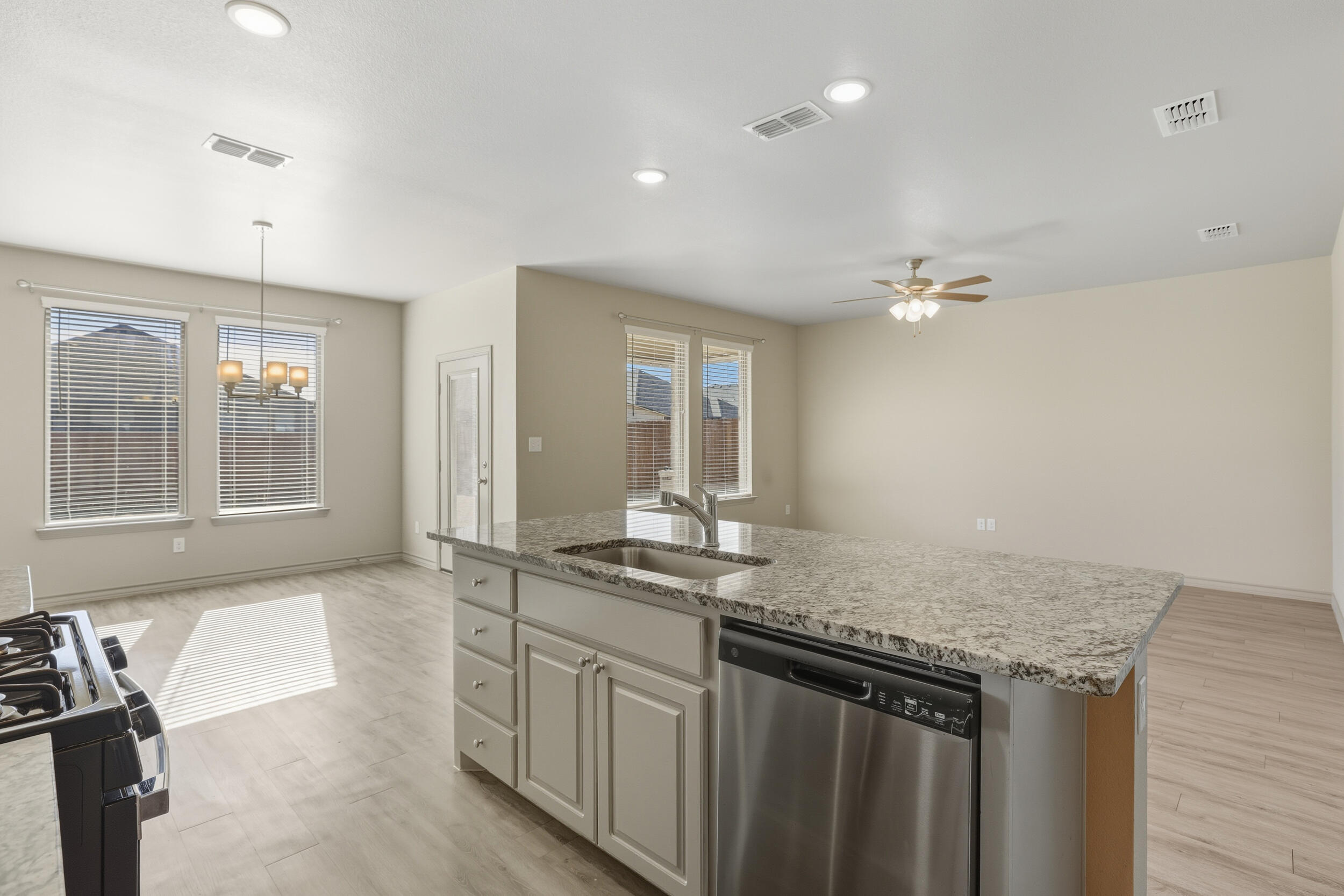 7103 22nd Street Lubbock, TX 79407 - Photo 7 of 30 a kitchen with granite countertop a sink and cabinets