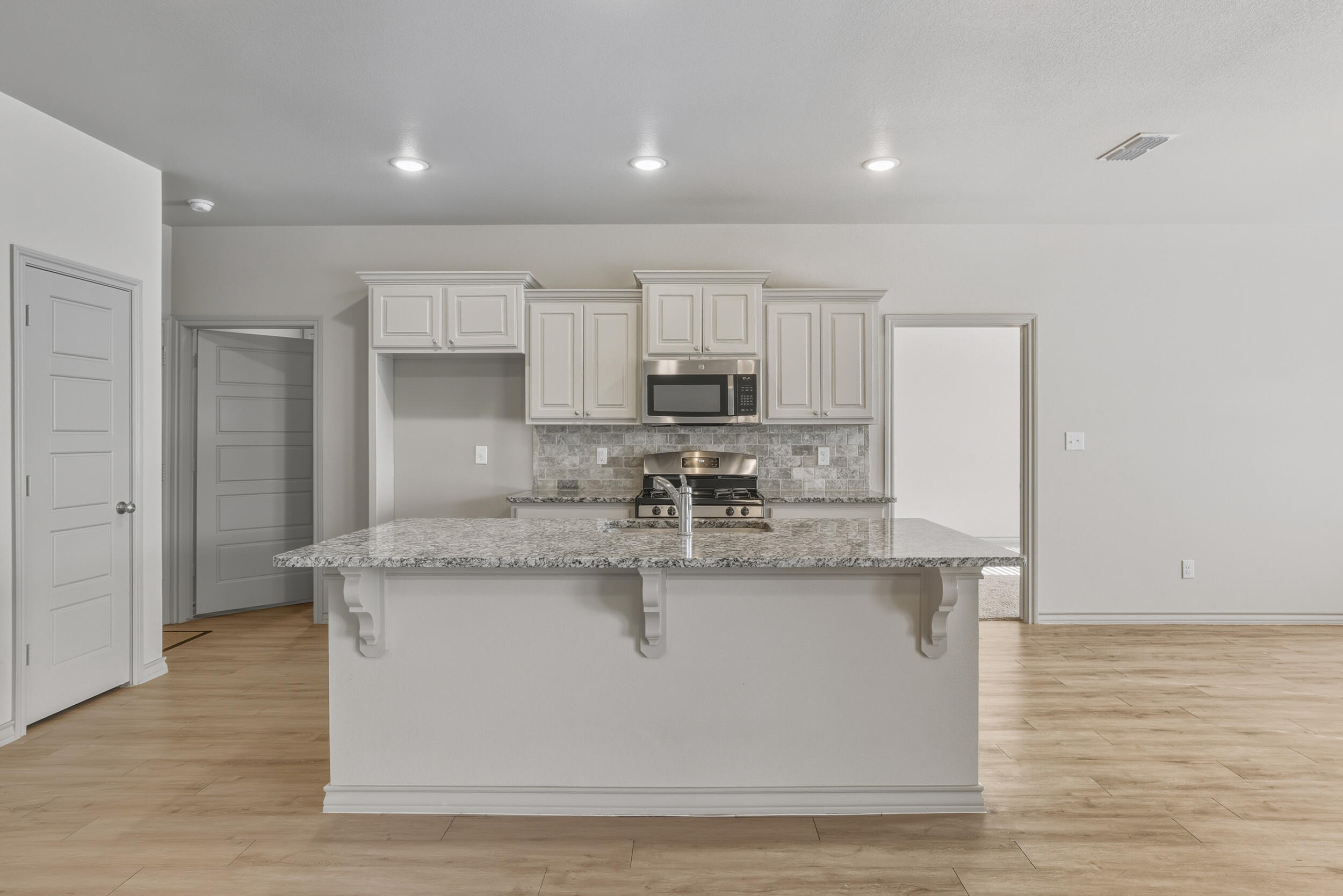 7103 22nd Street Lubbock, TX 79407 - Photo 9 of 30 a view of a kitchen with kitchen island a sink a counter top space and cabinets