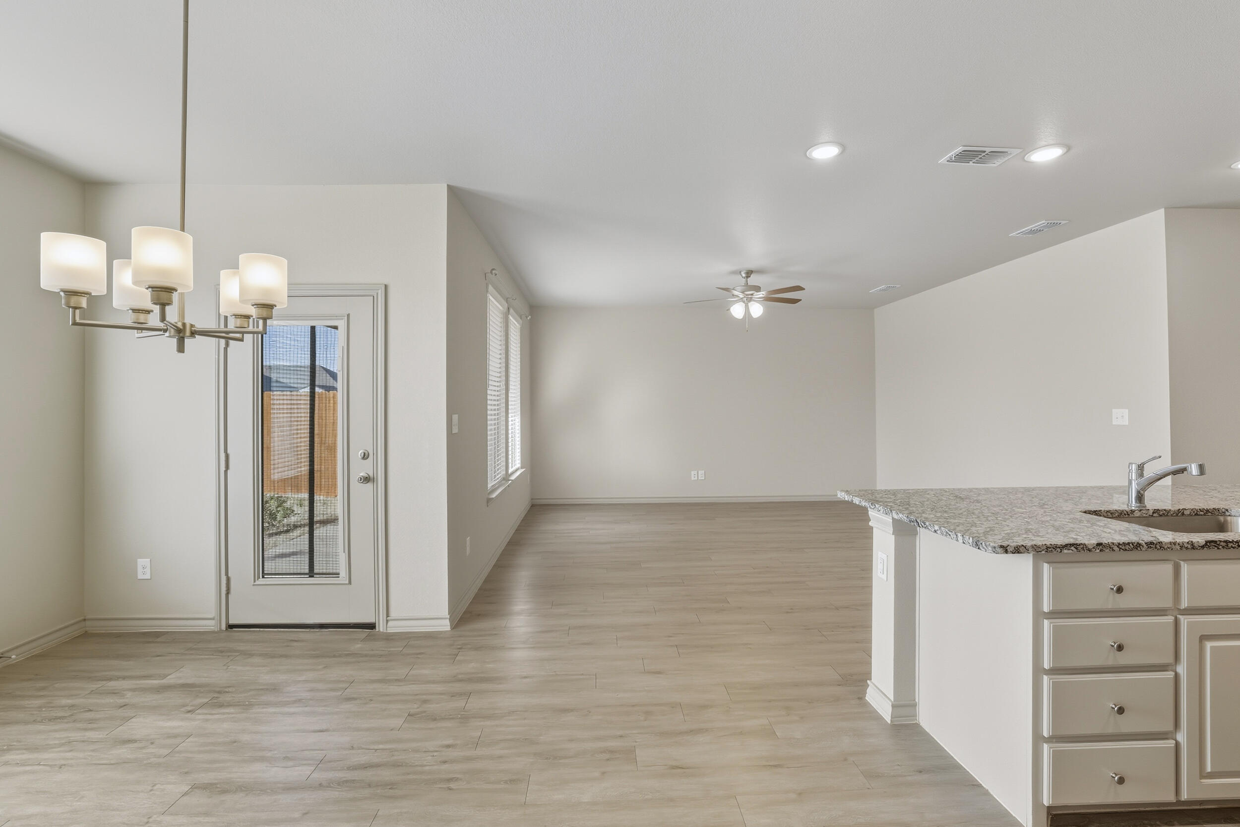 7103 22nd Street Lubbock, TX 79407 - Photo 10 of 30 a view of a kitchen cabinets and chandelier