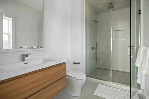 a bathroom with a sink toilet and shower