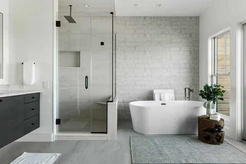 a white bath tub sitting next to a bathroom