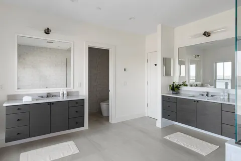 a spacious bathroom with a double vanity sink mirror and double