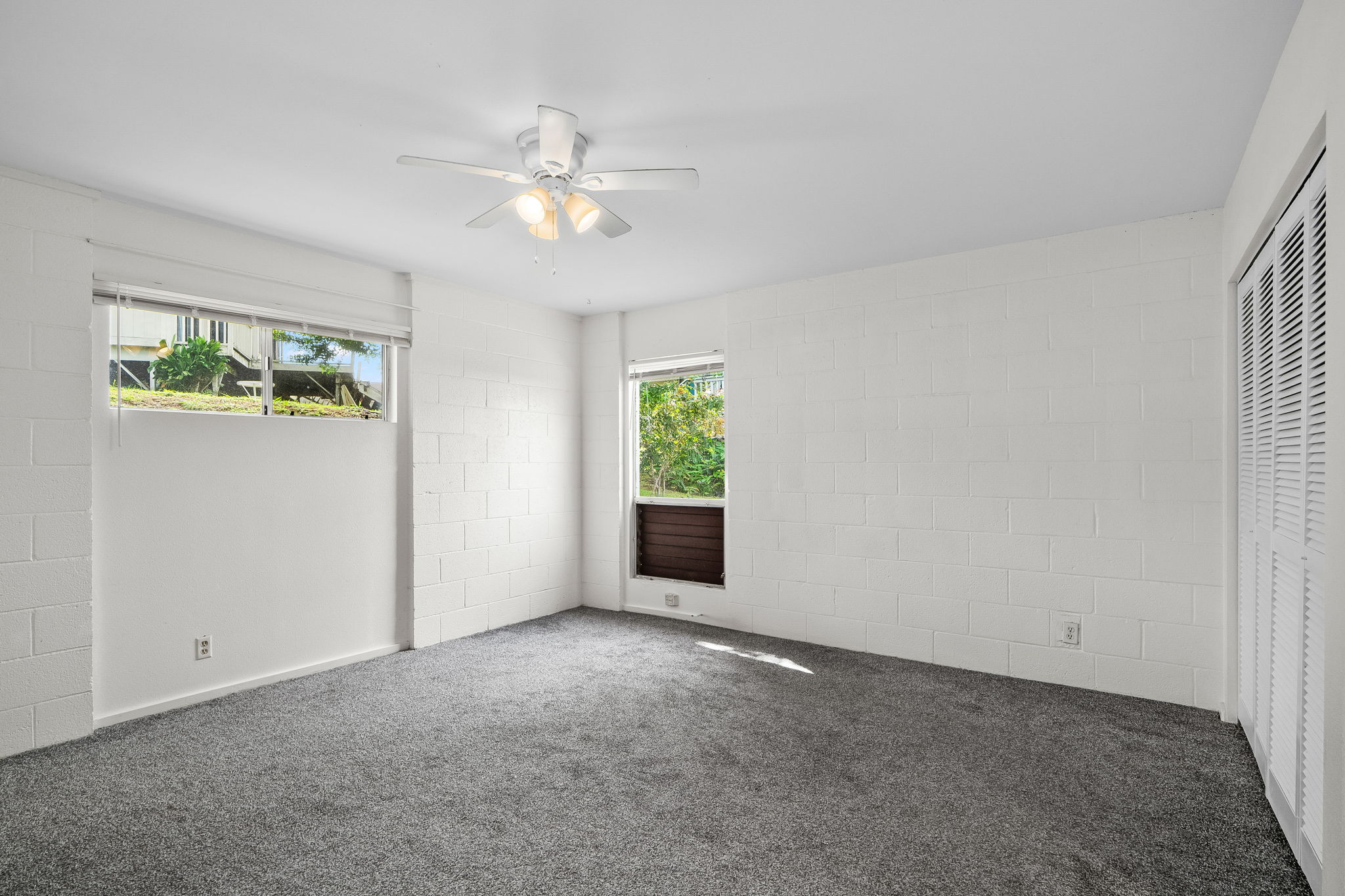 388 Molo Street Kapaa, HI 96746 - Photo 11 of 27 a view of an empty room with window chandelier fan