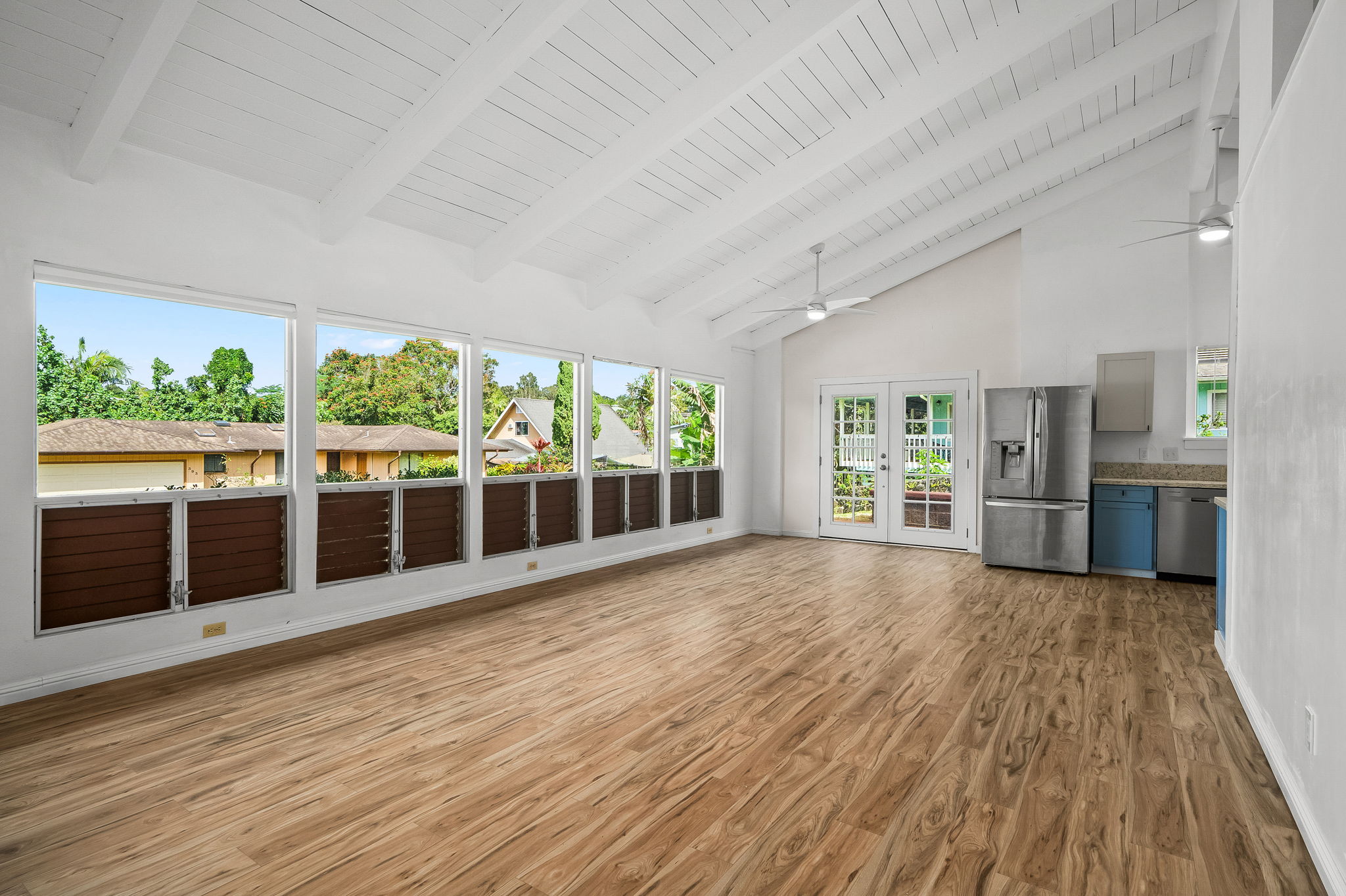 388 Molo Street Kapaa, HI 96746 - Photo 2 of 27 a view of an empty room with wooden floor and a window