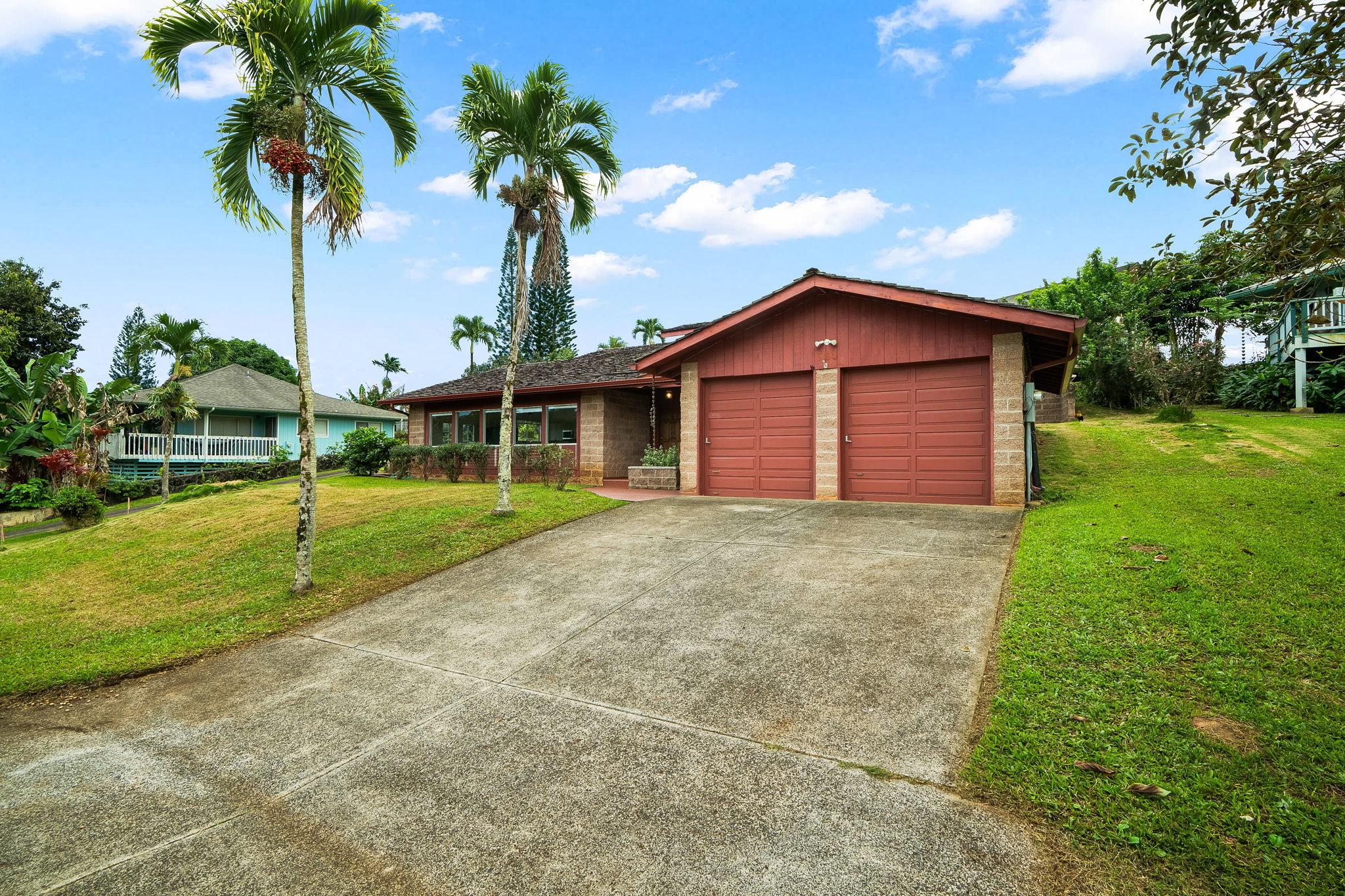 388 Molo Street Kapaa, HI 96746 - Photo 23 of 27 a view of a house with a yard and palm trees