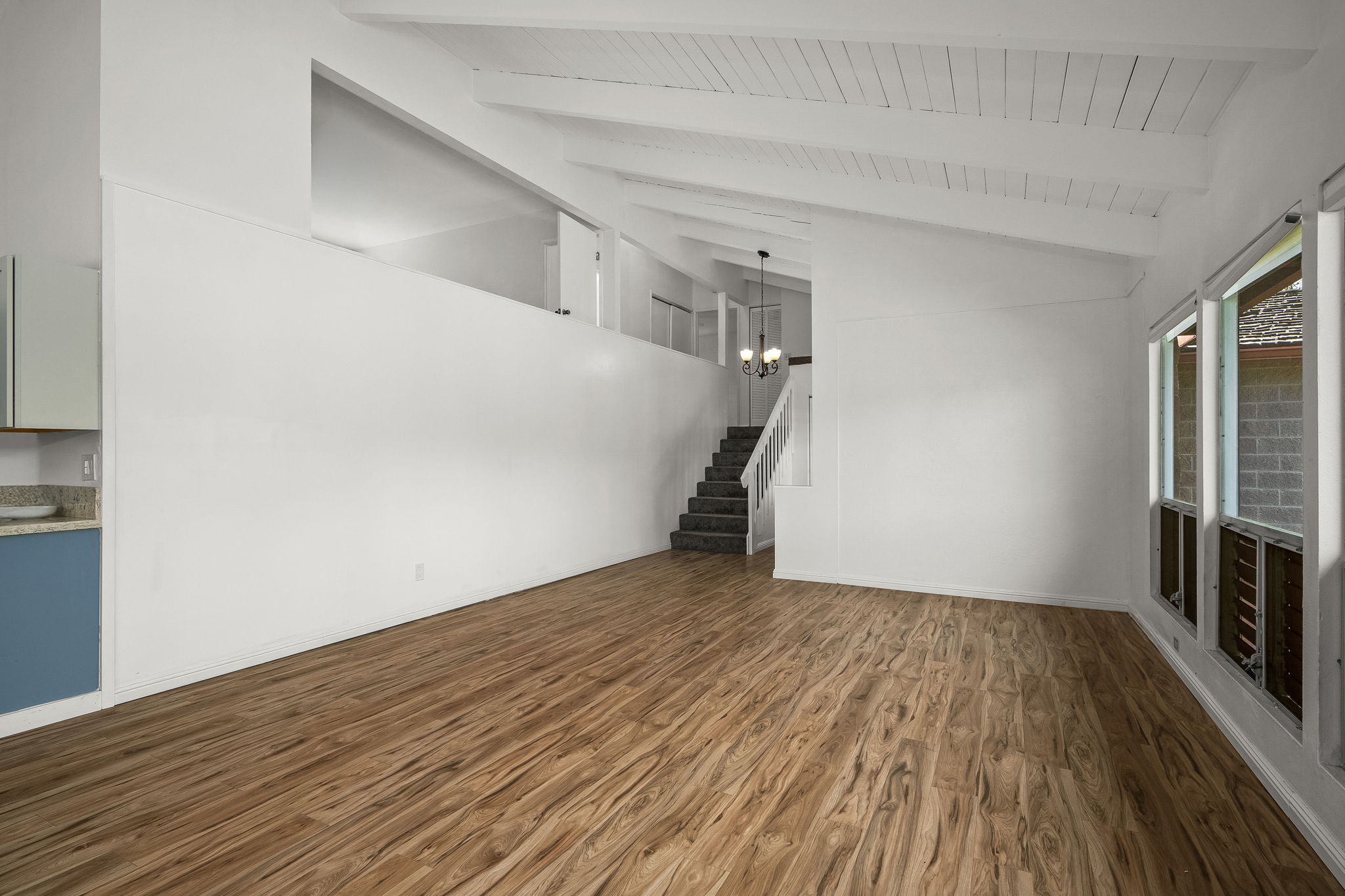 388 Molo Street Kapaa, HI 96746 - Photo 4 of 27 a view of empty room with wooden floor and fireplace