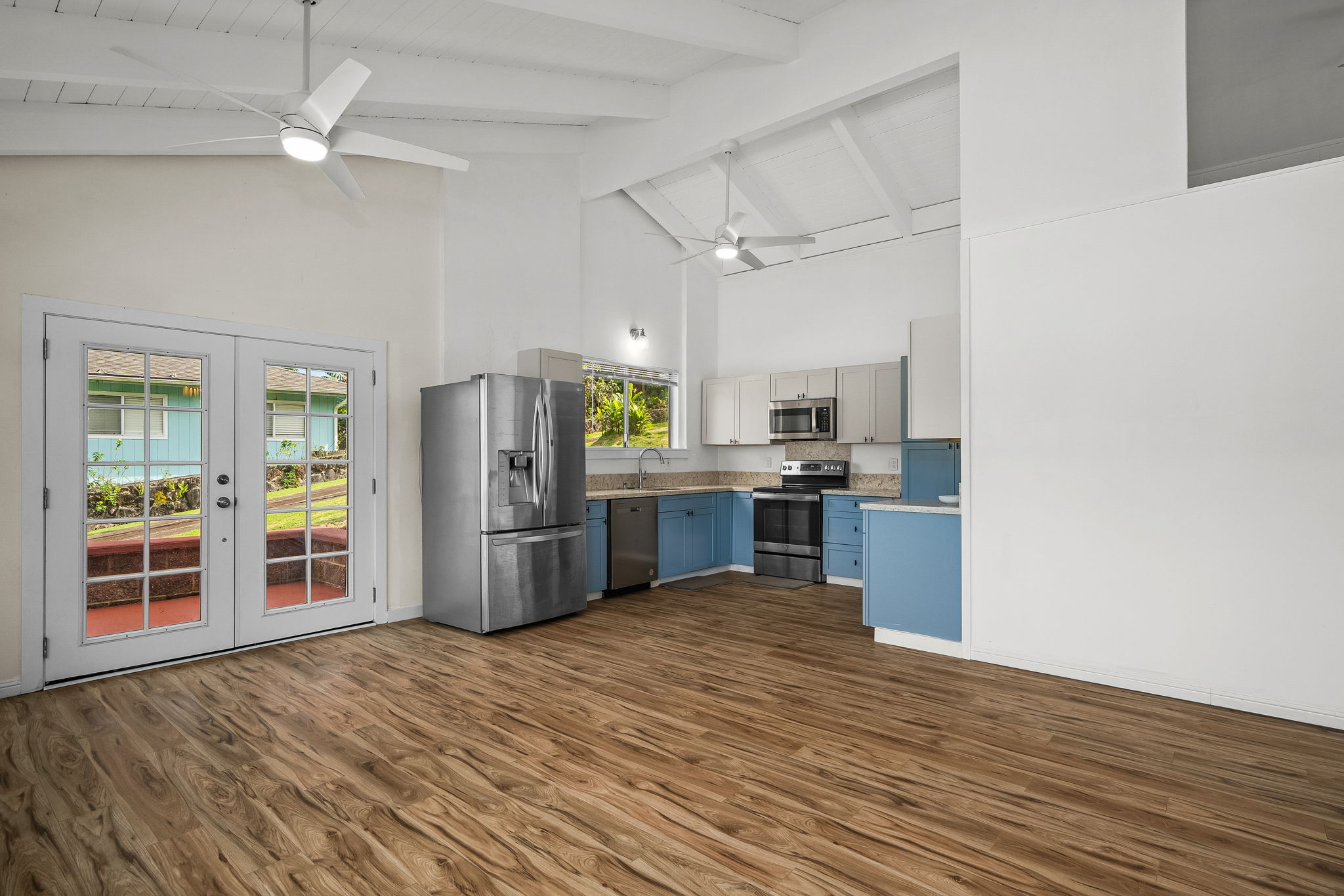 388 Molo Street Kapaa, HI 96746 - Photo 6 of 27 a kitchen with stainless steel appliances kitchen island granite countertop a refrigerator and a sink