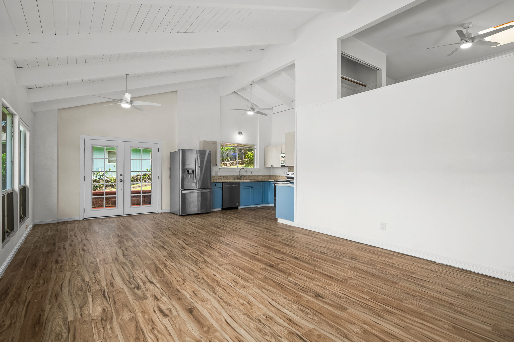 388 Molo Street Kapaa, HI 96746 - Photo 8 of 27 a view of a kitchen with wooden floor and a kitchen