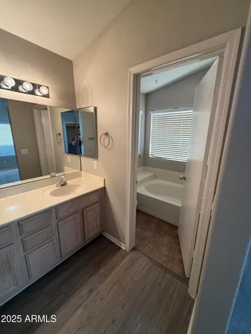 a bathroom with a double vanity sink and mirror