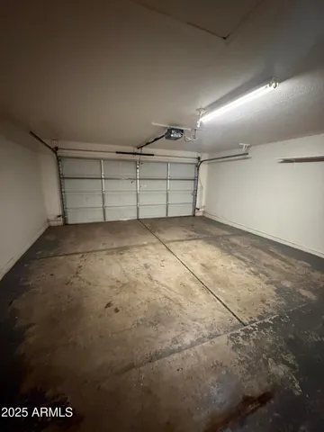 a view of a house with a yard and large parking space