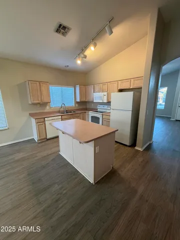 a kitchen with a refrigerator and a sink