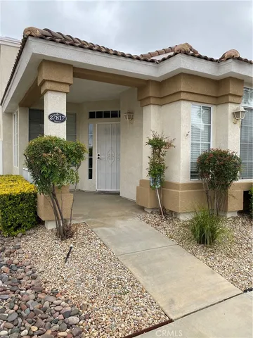 a view of a house with potted plants