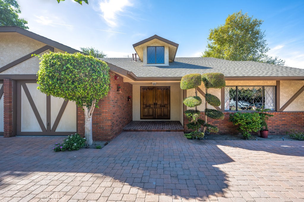 a front view of a house with garden