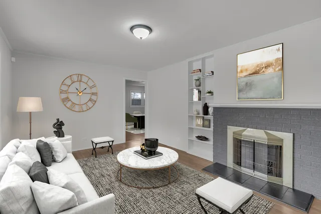 a living room with furniture a clock and a fireplace