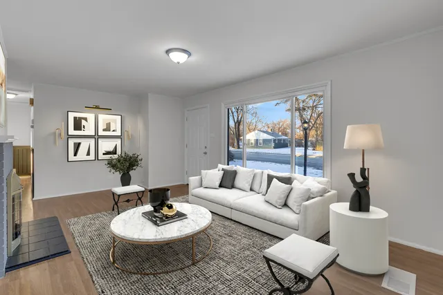 a living room with furniture a lamp paintings and a window