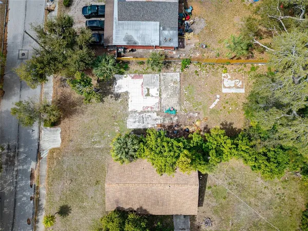 a green field with flowers in front of it