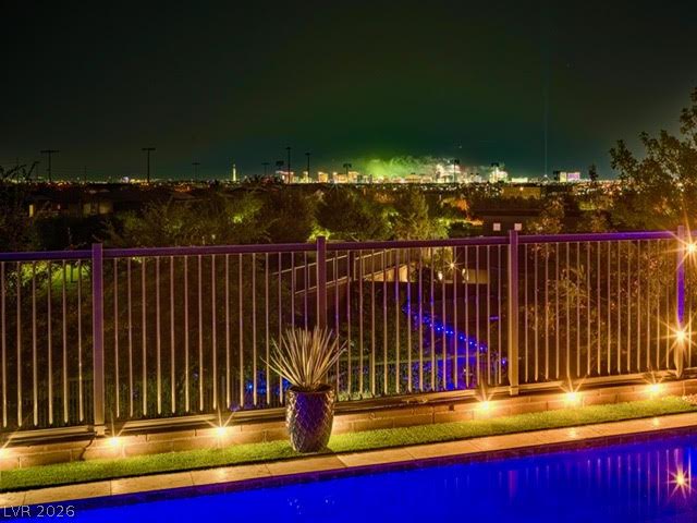 6014 Willow Ridge Court Las Vegas, NV 89135 - Photo 95 of 99 An illuminated pool deck offers sparkling city views under the night sky.