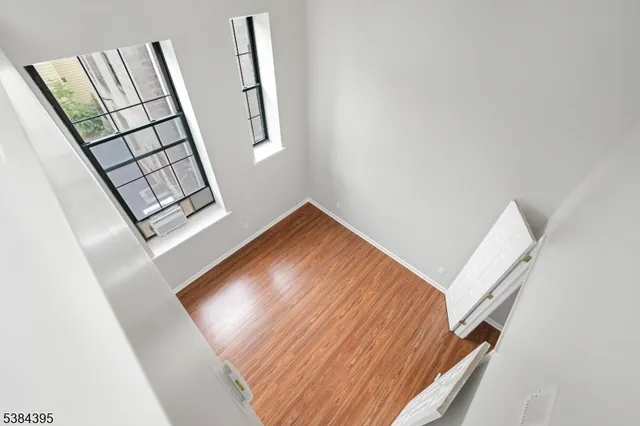 a view of staircase with white walls and a window